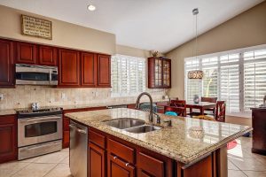 Updated Kitchen With Slab Granite and Stainless Appliances
